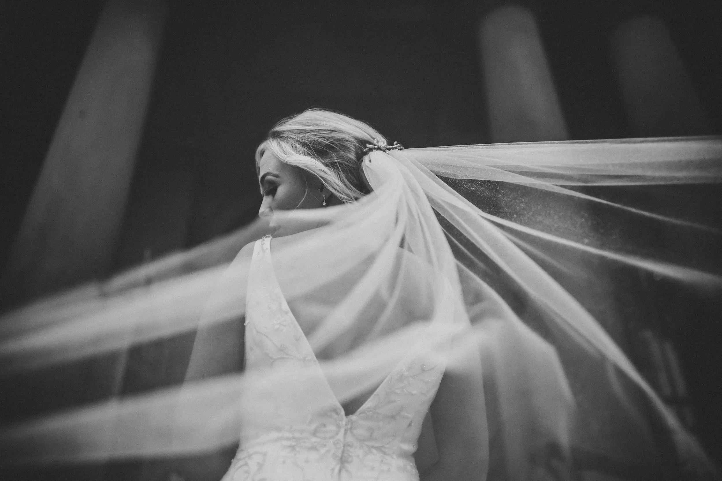 Bride in profile with her veil lifting in the wind